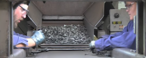 Two employees hand inspecting forged components